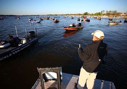 B.A.S.S. tournament director Chuck Harbin calls out boats numbers as Jared Lintner idles past.