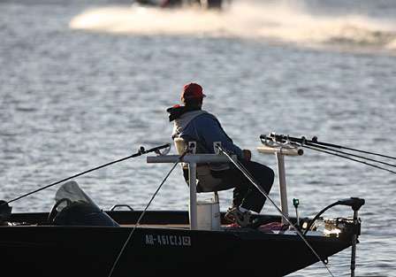 A crappie fisherman ignores his spider rig as he watches boats blast off.