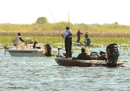 Elite Series anglers share a fishing spot with local fishermen. 