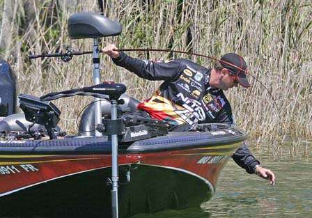 VanDam tries to find the handle on a 2 1/2-pound bass wearing a treble hook smile.
