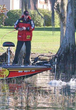 VanDam hauls a keeper out of Kissimmee grass in the shallows of Lake Harris.