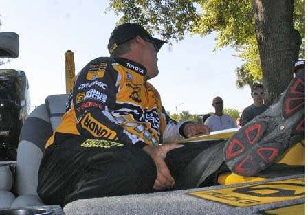 Terry Scroggins props his feet on his front deck and visits with fans during the drive-up weigh in.
