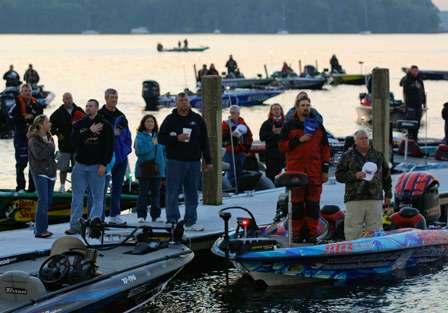 Marshals and anglers stand for the national anthem.