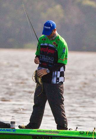 Scott Ashmore clears the grass away from another bass. 