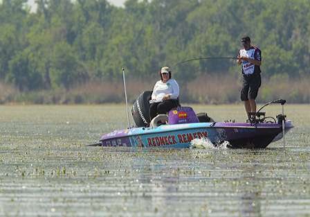 Billy McCaghren fights a nice-sized bass to his boat.
