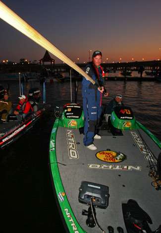 Dennis Tiejte loads a push pole in his boat. 