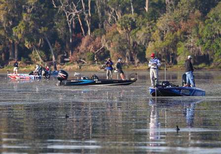 Elite anglers are lined up across a big grassbed.
