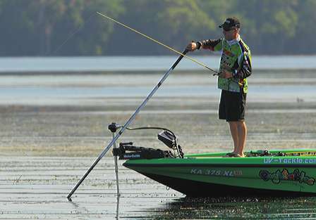 To not spook nearby fish, Brent Chapman poles slowly a short distance away to his next spot.