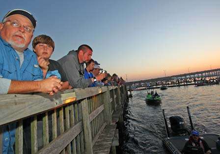 Spectators watch from the take-off dock as anglers file past.