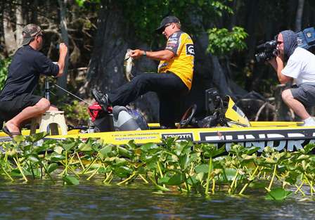 Scroggins moves to place the fish in the livewell, and Mark Zona and Brian Mason capture the action. 