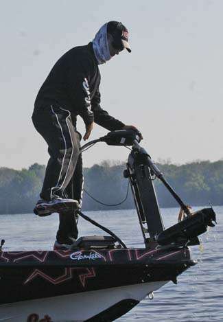 Hauling his trolling motor out of the water, John Crews does a dance step familiar to anglers moving from one hole to the next.
