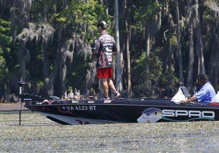 John Crews steps gingerly toward the bow of his boat to approach a big St. Johns bass.
