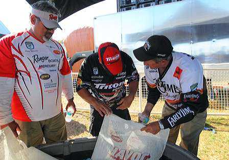Kevin Wirth shows off his big fish to fellow competitors Peter Thliveros and Fred Roumbanis.