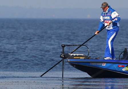 Alton Jones poles his boat while looking for fish on beds. 