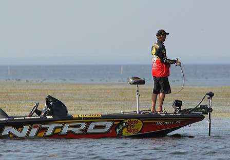 Kevin VanDam fishes the outside edge of a grassy area.