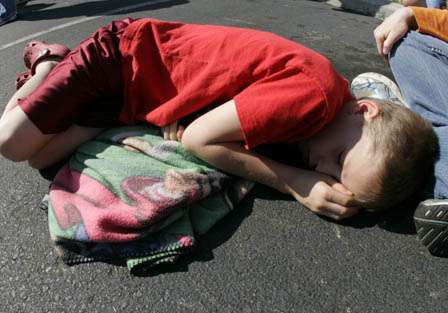 Kevin Huber, 9, up early to watch his dad launch at 7 a.m., gets in a little shuteye during the weigh-in.