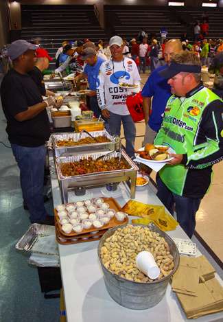 Anglers and their Marshals go through the food line for barbecue after the meeting. 
