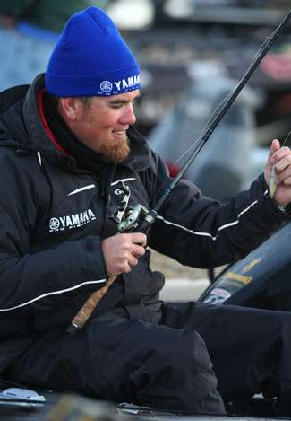Clark Reehm gets a lure stuck up his sleeve as he works on rods early Wednesday.