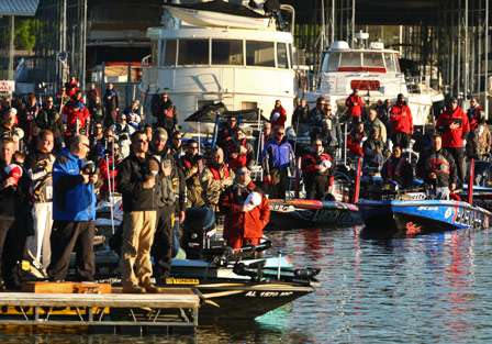 The field of anglers and their Marshals rise and remove their hats for the playing of the national anthem.