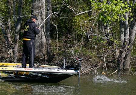 The bass makes an attempt to jump and spit the hook, but Scroggins plays it expertly to the boat.