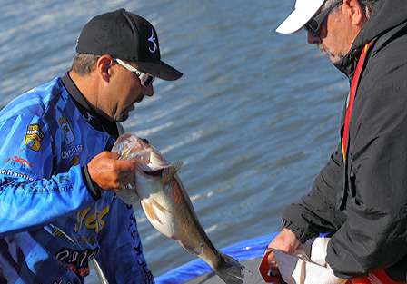 Chad Griffin, who sits in sixth place, gets a little help bagging his fish.
