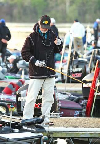 Rick Clunn spends a few moments checking a crankbait off the dock.
