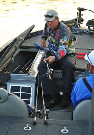 Russell Parrish takes the rod protectors off his rods while waiting for the Day Two launch.