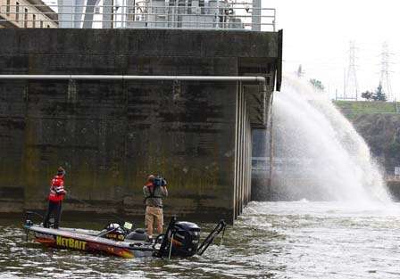Water spills out of the dam as Poche fishes his eddy.