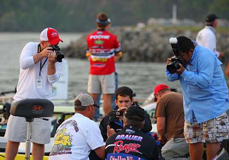 Media surround Day One leader Denny Brauer as he waits for a chance to get back after the bass on Pickwick Lake.