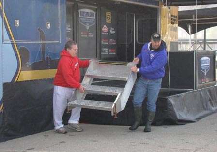 B.A.S.S. Youth Director Stacy Twiggs (right) receives help moving weigh-in equipment to higher ground.