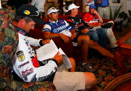 Edwin Evers checks out the angler briefing sheet while talking to his fellow competitors.