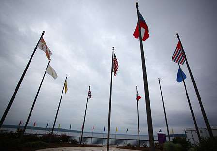 Flags gently wave under overcast skies on the morning of Day One.
