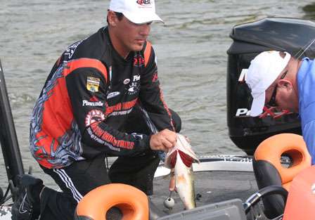 Grant Goldbeck transfers his stringer from livewell to weigh-in bag with his Marshal's help.
