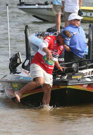 Keith Poche jumps from the bow of his boat on Day One.
