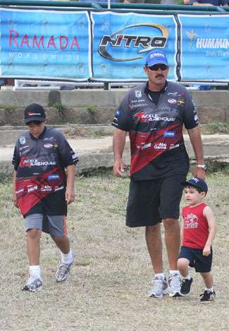 Jared Lintner walks to his boat after the weigh-in with sons J.C. (left) and Jayred (right).