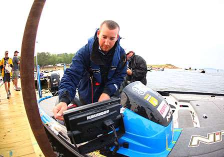 Rookie of the Year leader Ott Defoe checks over his boat before takeoff.