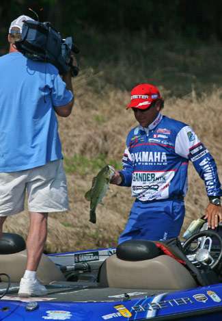 He walks the bass to the livewell as an ESPN camera films the action.