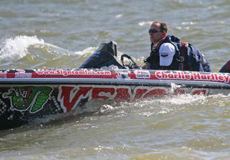 Charlie Hartley rides the trough of a big wave as he idles in on a windblown Toledo Bend.