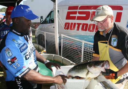 Ish Monroe watches as his 10 pound, 14 ounce largemouth is checked prior to the weigh-in.