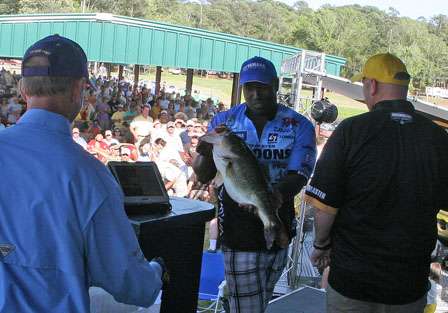 Ish Monroe gingerly holds the 10 pound, 14 ounce largemouth, the biggest fish of the event for the last two days.
