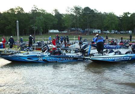 Anglers and boats gather around the dock near the launch.
