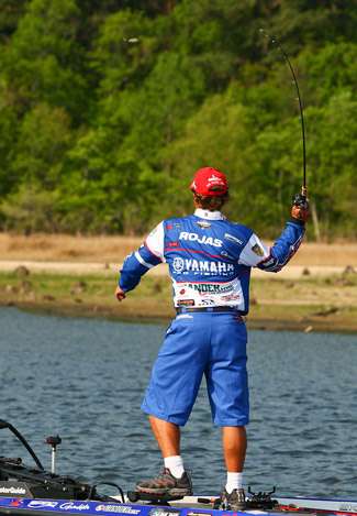 Rojas fires a one-handed cast with topwater bait. 