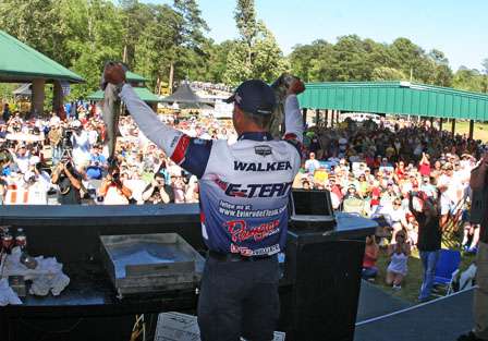Walker holds up two of his 24-pound stringer on Day Two in front of a large crowd.