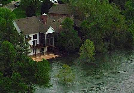 <p>
	Rising waters threaten another home. <span style=