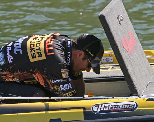 <p>
	Iaconelli goes into his storage compartment for a bait change on Sunday.</p>
