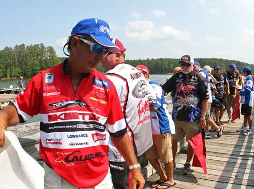 <p>
	Zell Rowland and a handful of other anglers wait to get a weigh-in bag on Day One. </p>

