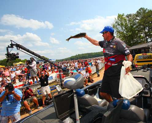 <p>
	Jared Lintner shows off his biggest fish of the day as ESPN cameras film the action.</p>
