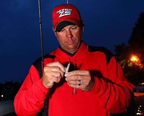 <p>
	Kevin VanDam ties on a lure prior to take-off Saturday.</p>
