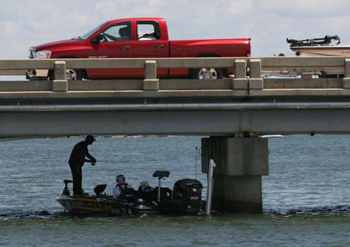 <p>
	A boat and truck cross the bridge Iaconelli is fishing under on Sunday.</p>
