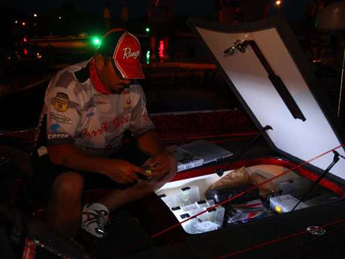 <p>
	Matt Greenblatt works on some tackle with the light in his boat compartment.</p>
